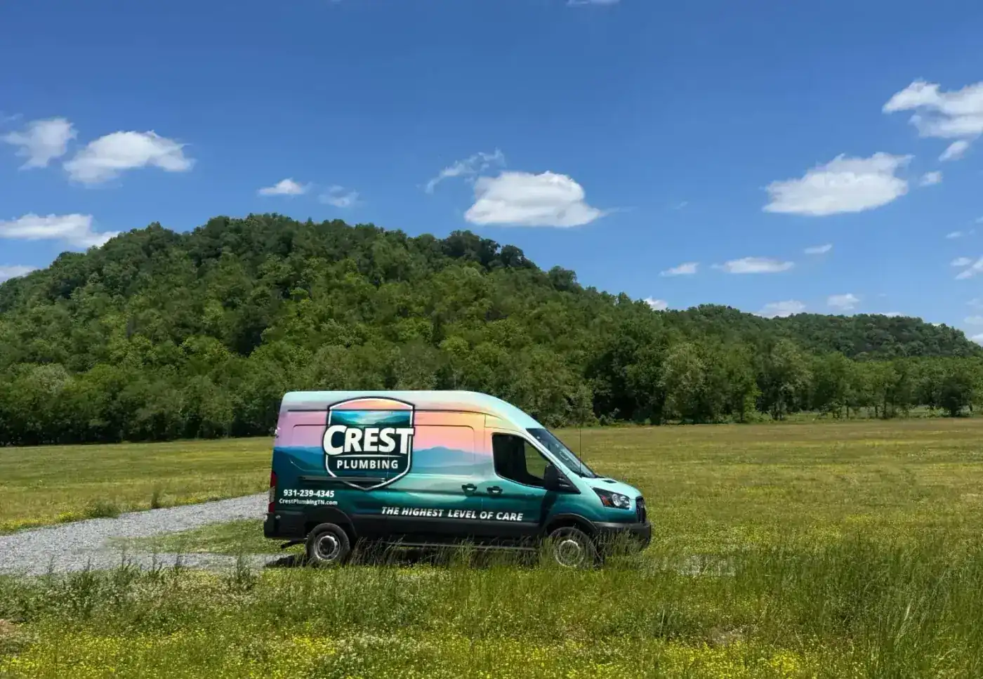 The Crest Plumbing service van in a Cookeville field at golden hour