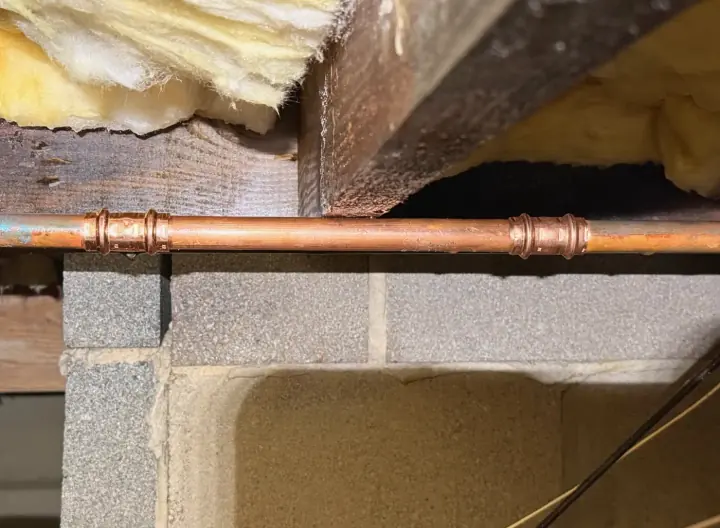Copper pipe repair in a crawlspace by Crest Plumbing