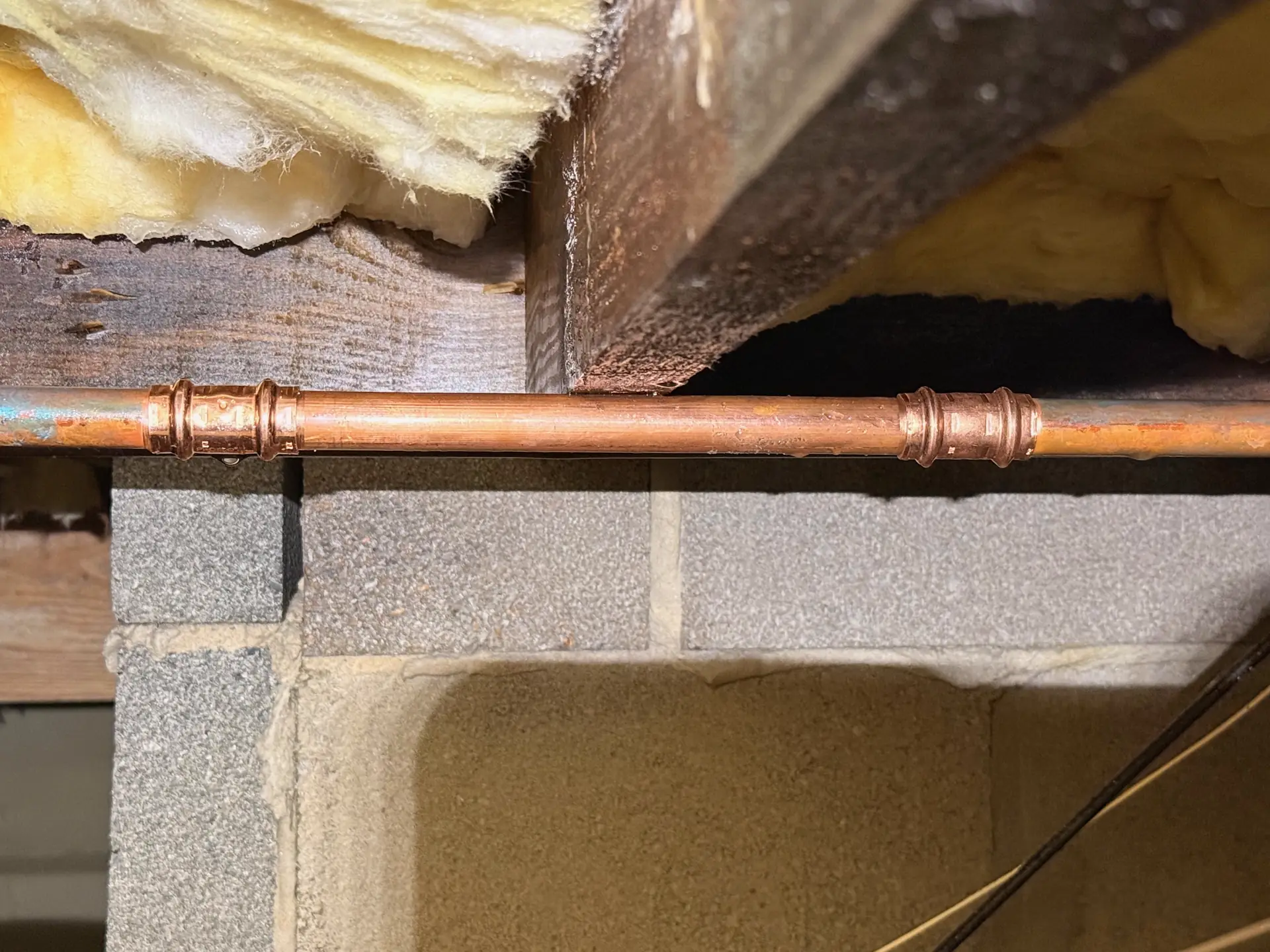 Copper pipe repair in a crawlspace by Crest Plumbing