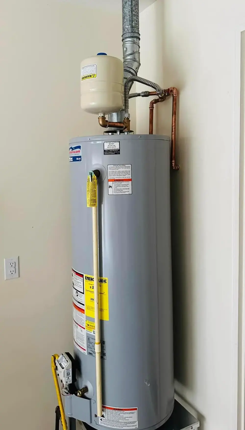 Tank water heater installed in a home closet by Crest Plumbing