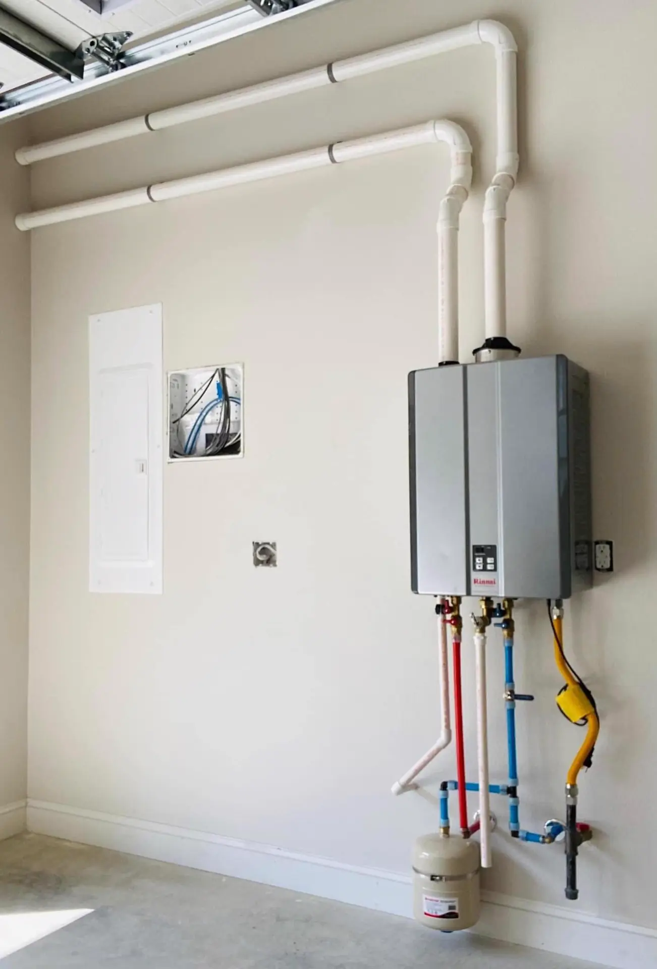 Tankless water heater on a utility wall