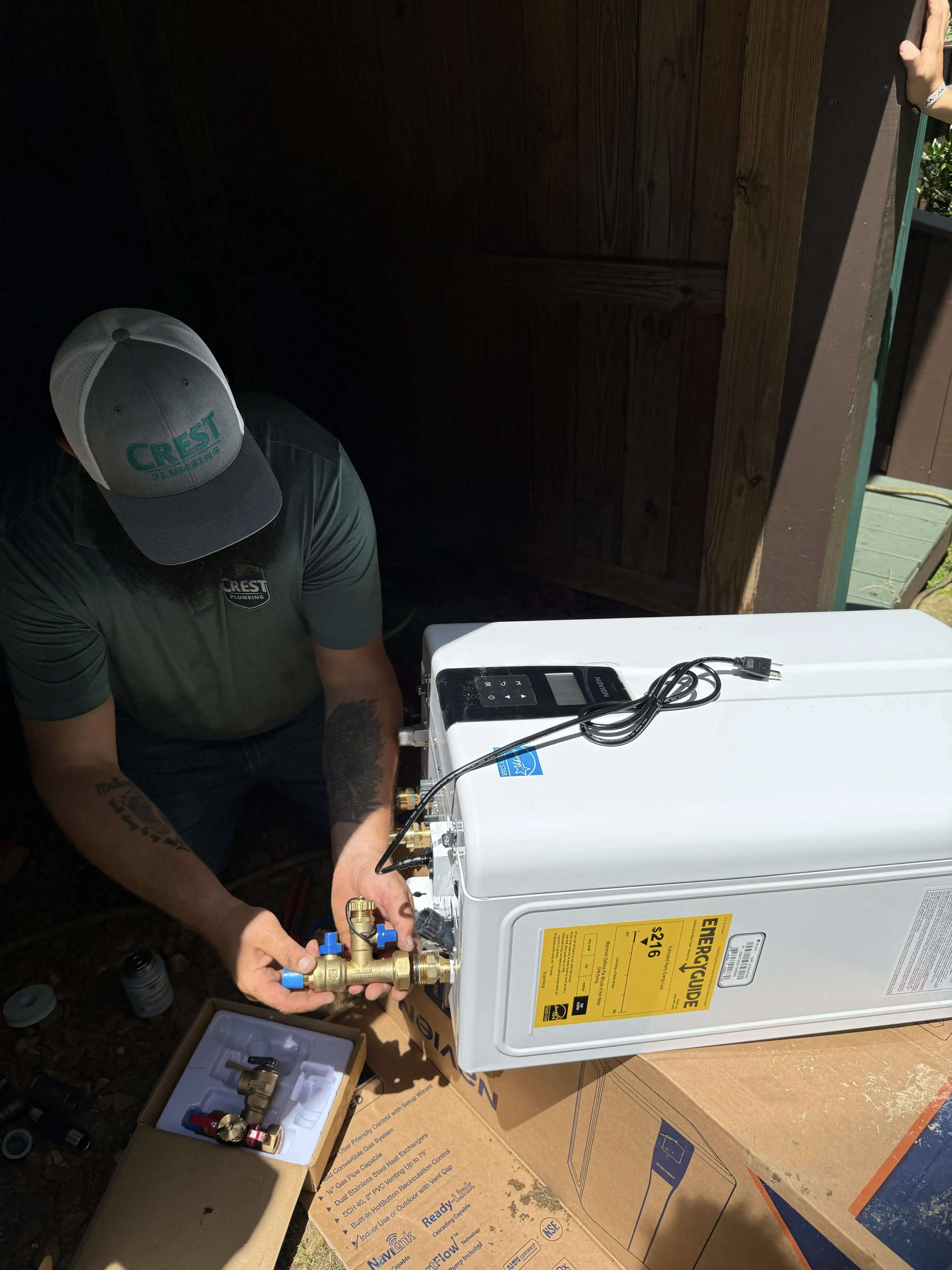Crest Plumbing technician servicing a tankless water heater