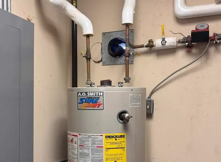 Tank water heater installed in a mechanical room by Crest Plumbing