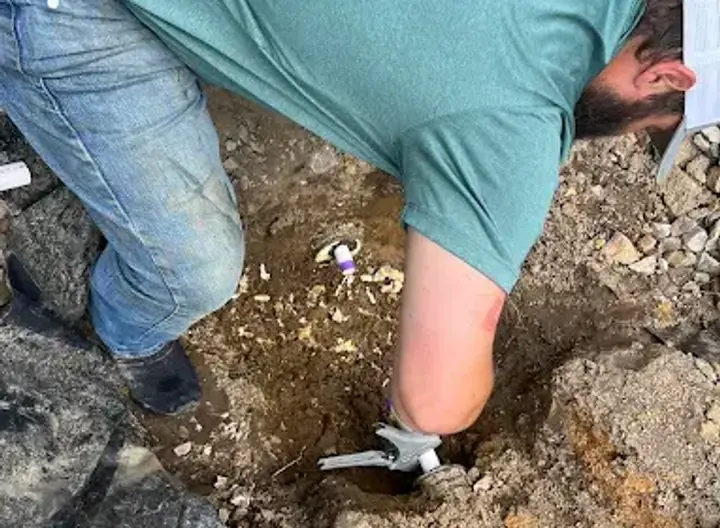 Crest Plumbing technician repairing an in-ground water line